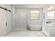 Bright bathroom features modern design with sleek tub, glass shower, and vanity with double sinks at 2370 W Los Arboles Pl, Chandler, AZ 85224