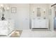 Elegant bathroom showcasing dual vanities, marble flooring, and stylish fixtures in a modern, bright space at 2370 W Los Arboles Pl, Chandler, AZ 85224