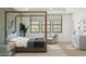 Serene bedroom featuring a four-poster bed, large windows, and neutral color scheme at 2370 W Los Arboles Pl, Chandler, AZ 85224