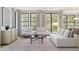 Bright living room with stylish furniture, large windows, and neutral tones at 2370 W Los Arboles Pl, Chandler, AZ 85224