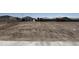 Developing land showing the initial construction, including framed houses in a construction area at 24091 W Bowker St, Buckeye, AZ 85326