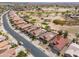 Residential neighborhood near a golf course, featuring single Gathering homes with tile roofs and desert landscaping at 2453 E Hancock Trl, Casa Grande, AZ 85194