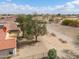 A backyard featuring desert landscaping, a privacy fence, and mature trees at 2453 E Hancock Trl, Casa Grande, AZ 85194