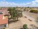 A backyard featuring desert landscaping, a privacy fence, and mature trees at 2453 E Hancock Trl, Casa Grande, AZ 85194