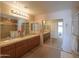 Bathroom with double sinks, a large mirror, and vanity with plenty of storage at 2453 E Hancock Trl, Casa Grande, AZ 85194