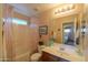 Cozy bathroom featuring a tub-shower combination, decor, and ample lighting at 2453 E Hancock Trl, Casa Grande, AZ 85194