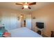 Comfortable bedroom featuring a ceiling fan, and an ensuite bathroom at 2453 E Hancock Trl, Casa Grande, AZ 85194