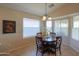 A breakfast nook with a round wooden table with seating for four and a chandelier at 2453 E Hancock Trl, Casa Grande, AZ 85194