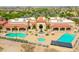 Aerial view of a clubhouse, pool, and manicured landscaping in a residential community at 2453 E Hancock Trl, Casa Grande, AZ 85194