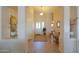 Welcoming entrance with neutral walls, tile flooring, and a view of the dining and living areas at 2453 E Hancock Trl, Casa Grande, AZ 85194