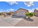 Attractive home with desert landscaping, a large driveway, and a neutral stucco exterior at 2453 E Hancock Trl, Casa Grande, AZ 85194