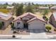 Charming home exterior with a well-maintained facade, desert landscaping, and a two-car garage at 2453 E Hancock Trl, Casa Grande, AZ 85194