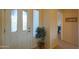 Bright entryway with a decorative glass door, tiled flooring, and a view into the hall at 2453 E Hancock Trl, Casa Grande, AZ 85194