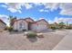 Charming home with a low maintenance desert landscape, gravel, shrubs, and a two-car garage at 2453 E Hancock Trl, Casa Grande, AZ 85194