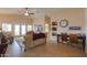 The living room has a ceiling fan, a desk, tile flooring, and sliding door access to the exterior at 2453 E Hancock Trl, Casa Grande, AZ 85194