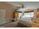 Spacious main bedroom with large windows, vaulted ceiling, and comfortable sitting area at 2453 E Hancock Trl, Casa Grande, AZ 85194