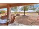 Inviting covered patio with outdoor seating and scenic desert landscape views at 2453 E Hancock Trl, Casa Grande, AZ 85194