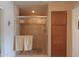 Beautiful tile shower with glass door, shelving, and a decorative cabinet at 2453 E Hancock Trl, Casa Grande, AZ 85194