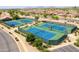 Aerial view of well-maintained tennis courts in a residential neighborhood at 2453 E Hancock Trl, Casa Grande, AZ 85194