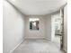 Clean and bright bedroom featuring a large window and a neutral color scheme, with view to the bathroom at 2526 E Novak Way, Phoenix, AZ 85042