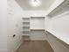 Walk-in closet with custom shelving and rod system at 2526 E Novak Way, Phoenix, AZ 85042