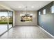 Dining room with tile floors, a modern chandelier, and views of the backyard at 2526 E Novak Way, Phoenix, AZ 85042