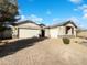 Charming home featuring a three-car garage, stone accents, and a paver driveway on a sunny day at 2526 E Novak Way, Phoenix, AZ 85042