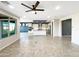 Open-concept living room featuring recessed lights, ceiling fan, and views of the modern kitchen with a center island at 2526 E Novak Way, Phoenix, AZ 85042
