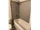 A view of a bathtub and shower with tiled walls at 2530 W Berridge Ln # E102, Phoenix, AZ 85017