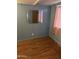 This is a view of the bedroom with wood floors, blue walls, and a mirrored closet door at 2530 W Berridge Ln # E102, Phoenix, AZ 85017