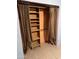 This is a view of a closet with custom shelving and bi-fold doors at 2530 W Berridge Ln # E102, Phoenix, AZ 85017
