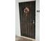 Inviting front door with black metal security screen at 2530 W Berridge Ln # E102, Phoenix, AZ 85017