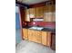 Kitchen featuring classic wood cabinets and dark countertops at 2530 W Berridge Ln # E102, Phoenix, AZ 85017