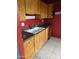 Cozy kitchen featuring classic wood cabinets and tile floors at 2530 W Berridge Ln # E102, Phoenix, AZ 85017