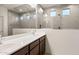 Bathroom featuring double vanity with modern faucets, shower, and a large mirror at 2658 N Coronado Dr, Florence, AZ 85132