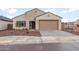 Inviting single-story home featuring a well-manicured yard and a two-car garage at 2658 N Coronado Dr, Florence, AZ 85132