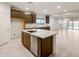 Modern kitchen with stainless steel appliances, dark cabinetry and a spacious island at 2658 N Coronado Dr, Florence, AZ 85132