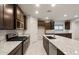 Well-equipped kitchen boasting granite countertops, stainless steel appliances and dark cabinets at 2658 N Coronado Dr, Florence, AZ 85132