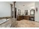 Luxurious bathroom featuring granite countertops, dual vanities, elegant light fixtures and decorative columns at 27708 N 110Th Pl, Scottsdale, AZ 85262