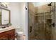 This bathroom features a tiled shower, vanity with framed mirror and a toilet at 27708 N 110Th Pl, Scottsdale, AZ 85262