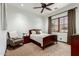 Charming bedroom with a ceiling fan, a side chair, and a large window with desert views at 27708 N 110Th Pl, Scottsdale, AZ 85262