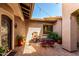 Intimate outdoor courtyard setting with dining table and fountain at 27708 N 110Th Pl, Scottsdale, AZ 85262