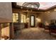 Enchanting courtyard featuring an outdoor fireplace, elegant iron door, and string lights for ambient lighting at 27708 N 110Th Pl, Scottsdale, AZ 85262