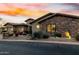 Lovely single-Gathering home with an attached three-car garage, desert landscaping, and inviting facade at sunset at 27708 N 110Th Pl, Scottsdale, AZ 85262