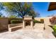 Inviting outdoor fireplace area featuring a charming fireplace with built-in benches, great for outdoor living at 27708 N 110Th Pl, Scottsdale, AZ 85262