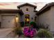 Charming home exterior featuring a well-manicured front yard and gated courtyard entrance at 27708 N 110Th Pl, Scottsdale, AZ 85262