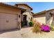 Home featuring an arched entrance and lush desert landscaping at 27708 N 110Th Pl, Scottsdale, AZ 85262