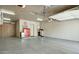 Spacious garage interior featuring ample storage cabinets, epoxy flooring, and room for multiple vehicles at 27708 N 110Th Pl, Scottsdale, AZ 85262