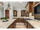 A well-equipped kitchen features custom cabinets, granite countertops, and stainless steel appliances at 27708 N 110Th Pl, Scottsdale, AZ 85262