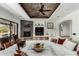 Inviting living room with fireplace, ceiling fan, and stylish furnishings at 27708 N 110Th Pl, Scottsdale, AZ 85262